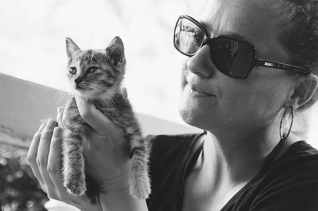Woman holding and admiring her kitten