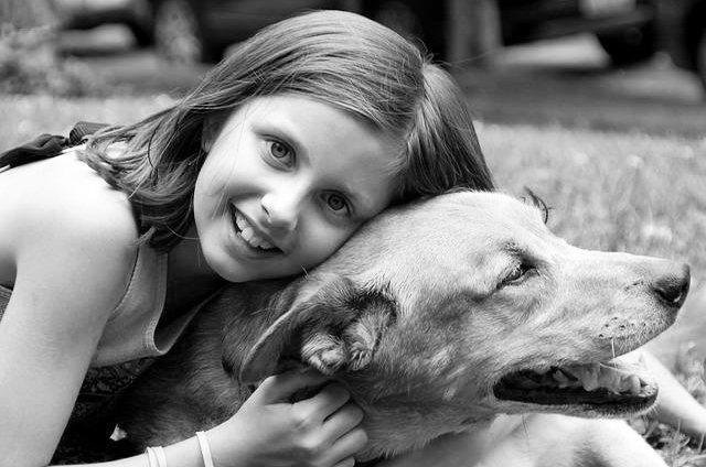Young girl hugging her dog