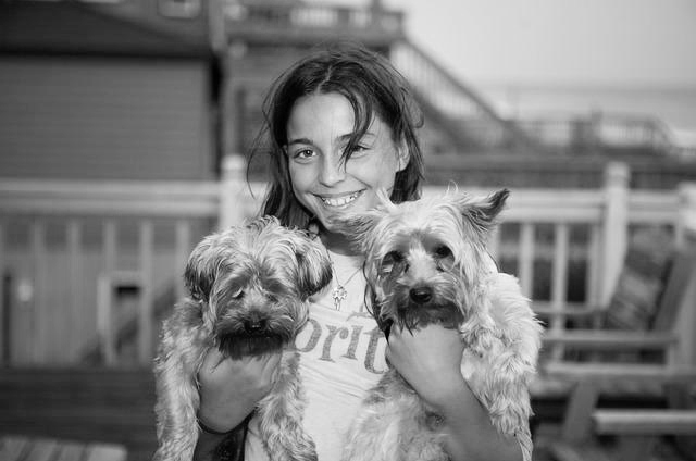 Woman holding two dogs